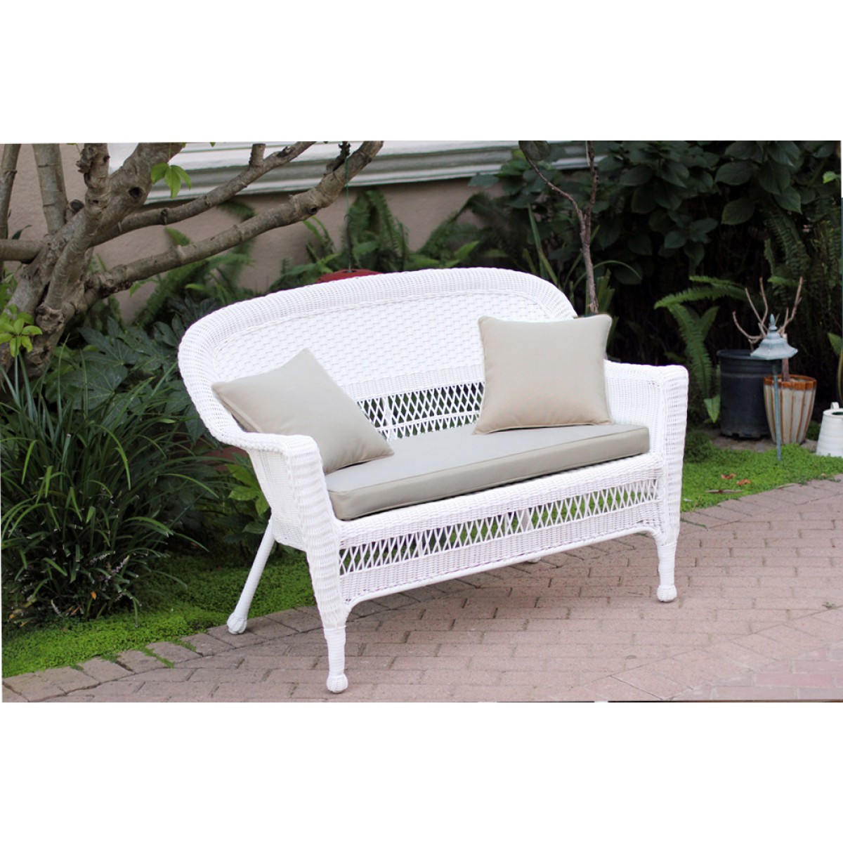 White Wicker Patio Love Seat With Tan Cushion and Pillows