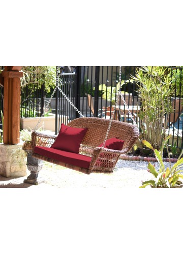 Honey Resin Wicker Porch Swing with Red Cushion