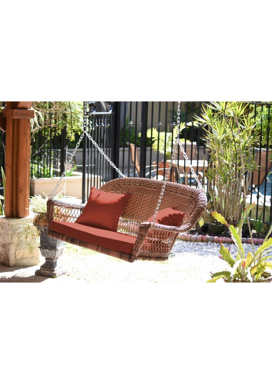 Honey Resin Wicker Porch Swing with Brick Red Cushion
