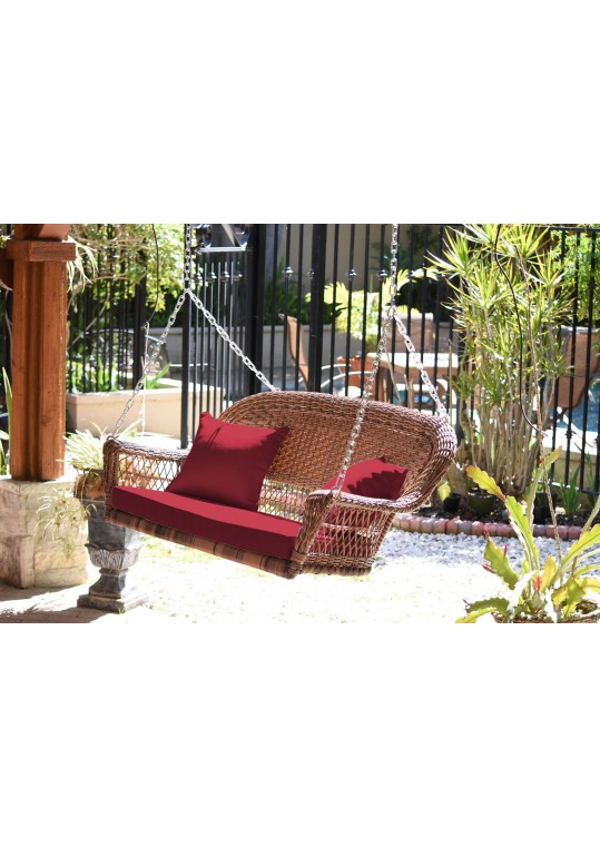 Honey Resin Wicker Porch Swing with Red Cushion