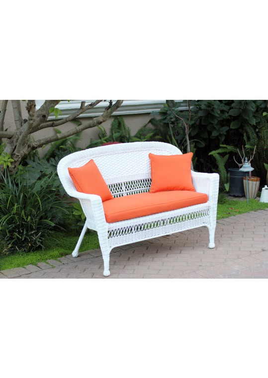 White Wicker Patio Love Seat With Orange Cushion and Pillows